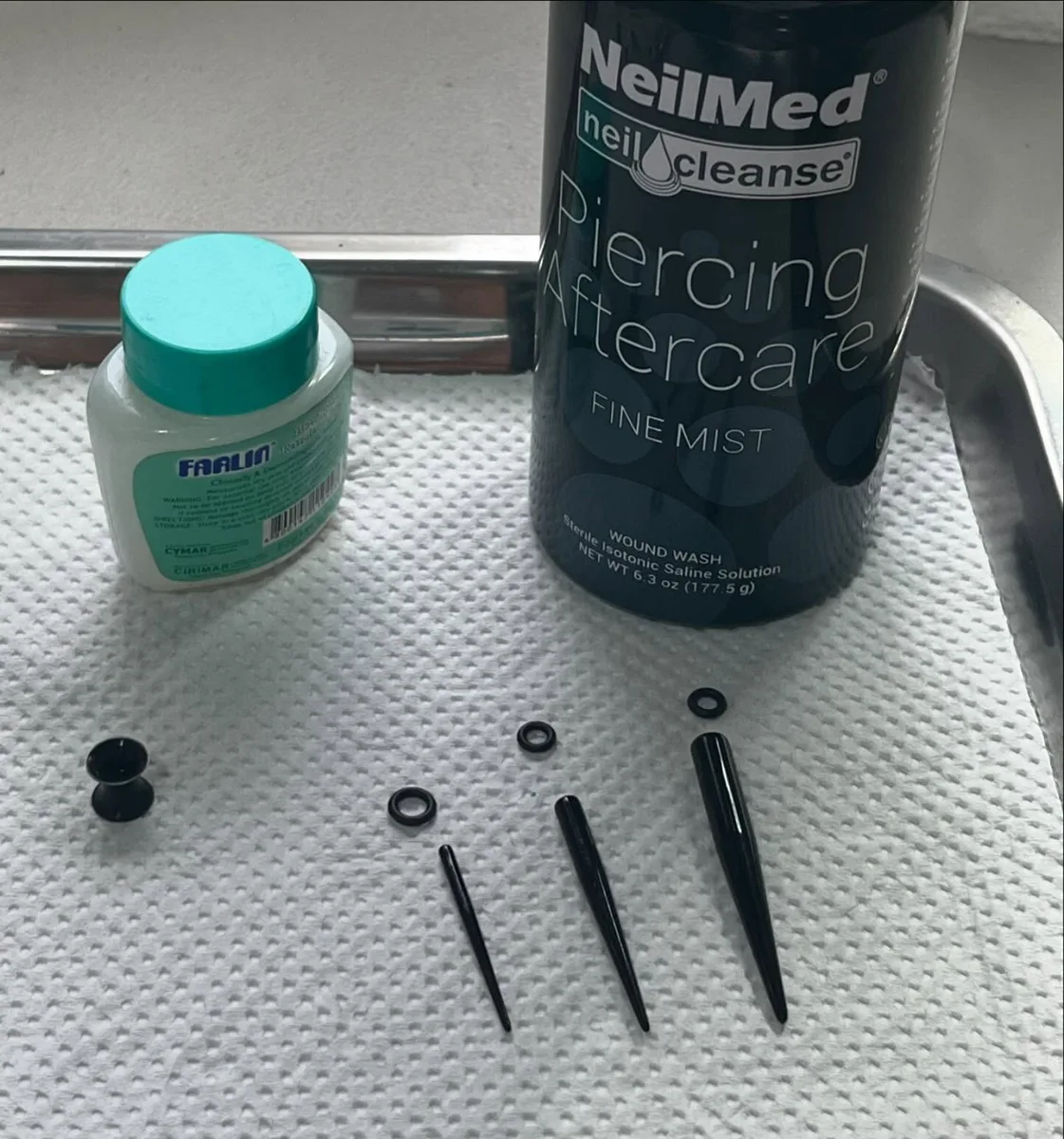 Ear stretching kit with black tapers, plug, O-rings and NeilMed piercing aftercare saline spray